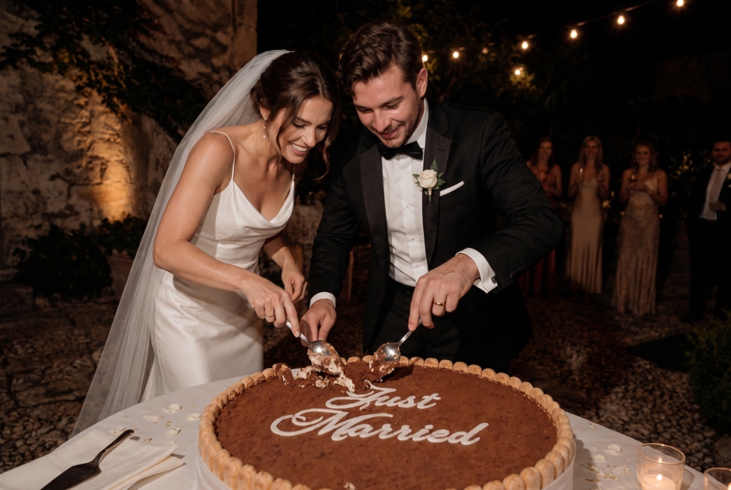 Bride and groom cutting Maggie's Giant Wedding Tiramisù with spoons